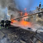 Firefighters work at a site of a Russian missile strike in Kyiv