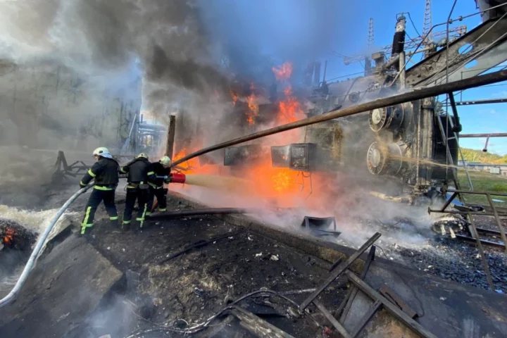 Firefighters work at a site of a Russian missile strike in Kyiv