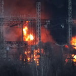 Smoke and fire are seen around high-voltage lines at a site of a Russian missile strike outside Kharkiv