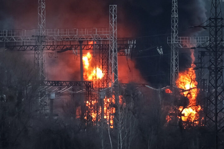 Smoke and fire are seen around high-voltage lines at a site of a Russian missile strike outside Kharkiv