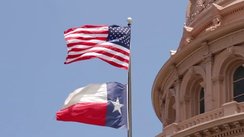4 The US and Texas State flags fly at the Texas Capitol building